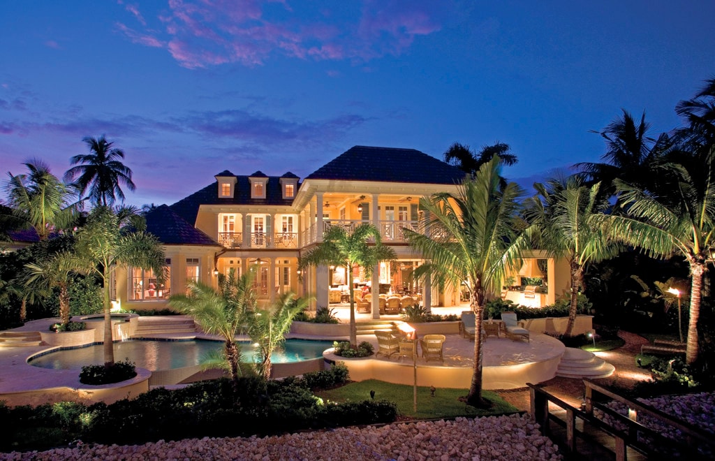 Palm-lined pool estate at twilight