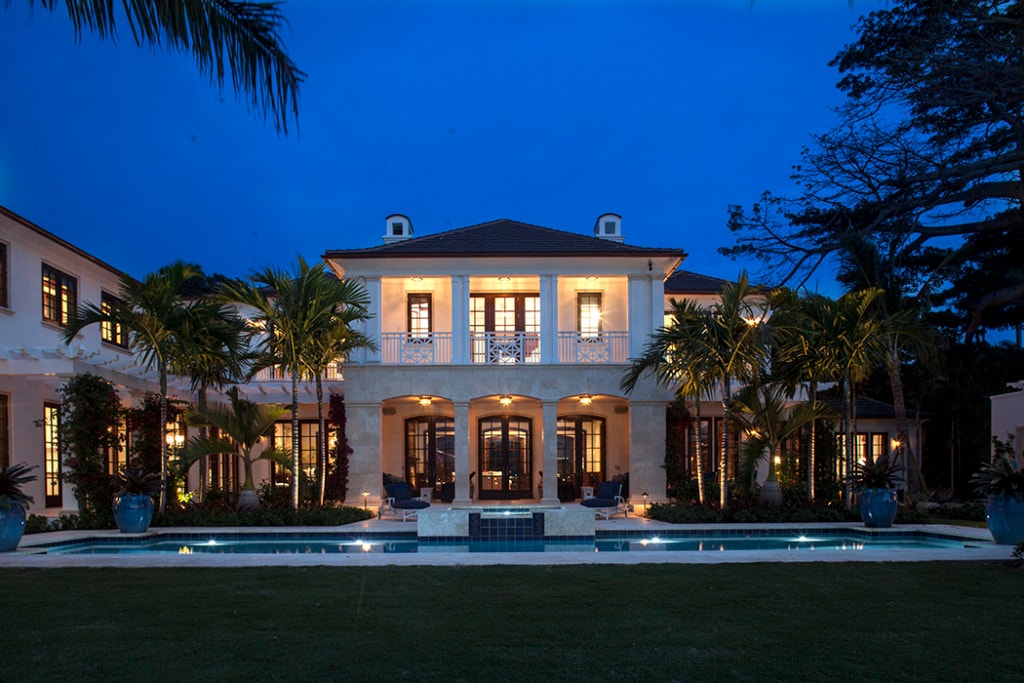 Neoclassical estate with rectangular pool and manicured lawn