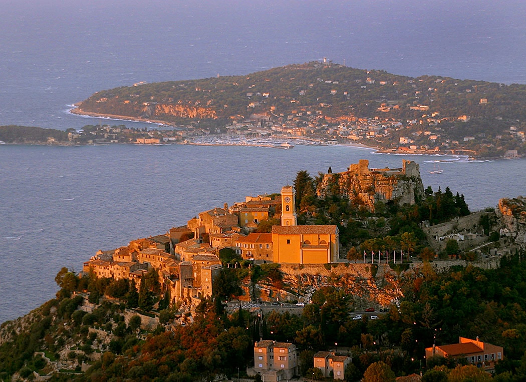 Medieval hilltop village overlooking the Mediterranean coast at golden hour